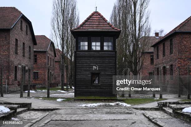 View of barbed wire fence and surveillance towers at the former Nazi death camp Auschwitz I on January 26, 2023 in Oswiecim, Poland. International...