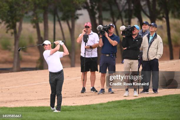 Rory McIlroy of Northern Ireland plays their second shot on the 10th hole during Day One of the Hero Dubai Desert Classic at Emirates Golf Club on...