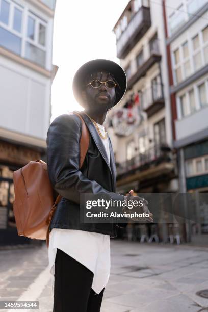 portrait of black man looking at the camera on a city street - vestimenta 個照片及圖片檔