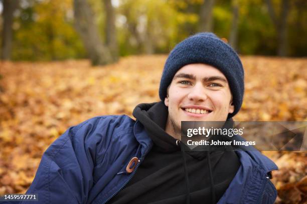 smiling man looking at camera - lying on side stock pictures, royalty-free photos & images