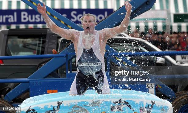 Professor Splash, Darren Taylor, celebrates after achieving a world record of diving from 30ft into 12inches of Cornish milk, at the Royal Cornwall...