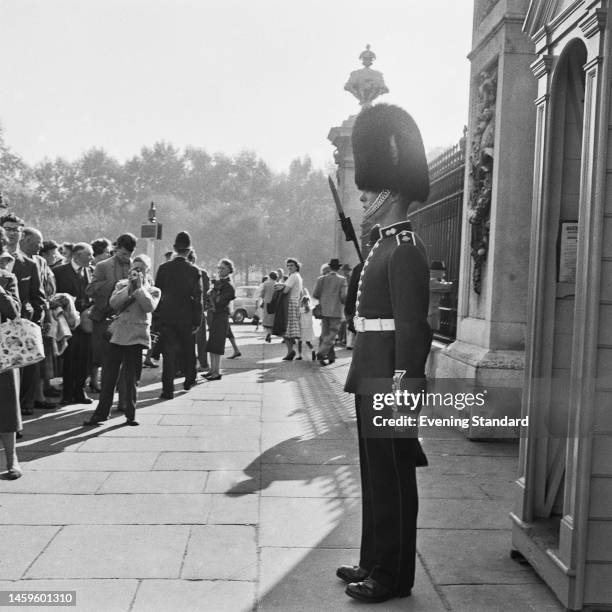 Crowd await the 'Changing of the Guard' ceremony which is to take place outside the gates of Buckingham Palace for the final time, on October 16th,...