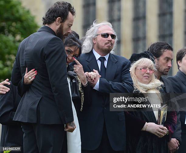 Bee Gee Barry Gibb, and Dwina Murphy Gibb, brother and wife of Robin Gibb, attend his funeral at St Mary's Church in Thame, central England, on June...