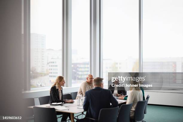 people talking during business meeting - governing board foto e immagini stock