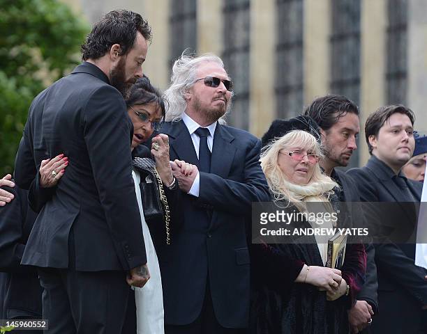 Bee Gee Barry Gibb, and Dwina Murphy Gibb, and Robin-John Gibb brother, wife and son of Robin Gibb, attend his funeral service at St Mary's Church in...