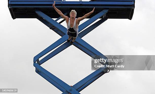 Professor Splash, Darren Taylor, attempts a world record of diving from 30ft into 12inches of Cornish milk at the Royal Cornwall Show on June 8, 2012...
