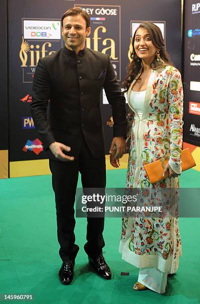 Bollywood actor Vivek Oberoi poses with wife Priyanka on the green carpet for the International Indian Film Academy awards 'Rocks' event, in...
