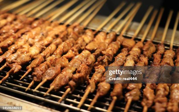 grilling lamb kebabs on the barbecue - skewer stock pictures, royalty-free photos & images