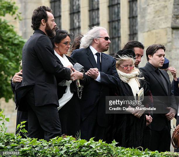 Barry Gibb , Robin's widow Dwina Murphy Gibb and Robin's son Robin-John Gibb attend the funeral of Robin Gibb held at St. Mary's Church, Thame on...