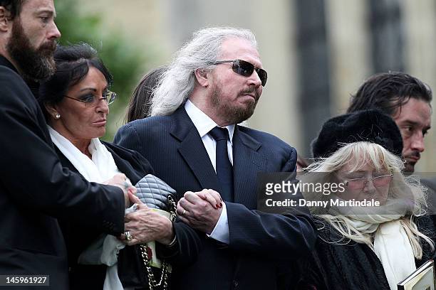 Barry Gibb and Robin's widow Dwina Murphy Gibb attend the funeral of Robin Gibb held at St. Mary's Church, Thame on June 8, 2012 in Oxford, England.