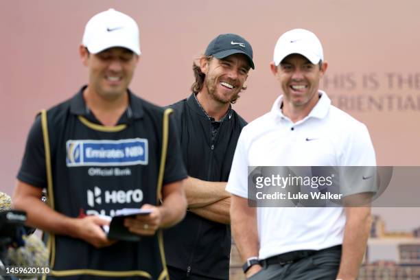 Tommy Fleetwood of England laughs with Rory McIlroy of Northern Ireland on the 11th tee during Day One of the Hero Dubai Desert Classic at Emirates...