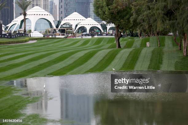 Robert MacIntyre of Scotland tees off on the 1st hole as water is seen on course during Day One of the Hero Dubai Desert Classic at Emirates Golf...