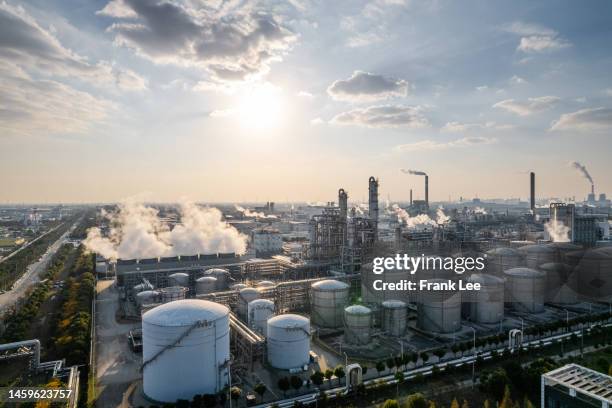 aerial view of twilight of oil refinery ,shot from drone of oil refinery plant ,refinery petrochemical plant at daytime, shanghai, china - raffinerie stock-fotos und bilder