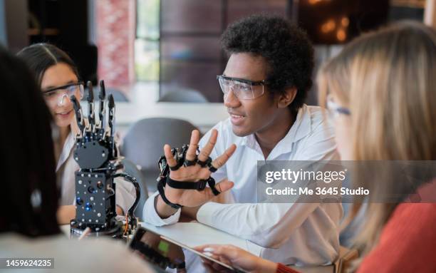 teenagers and children sit in the robot science workshop - innovation lab stock pictures, royalty-free photos & images