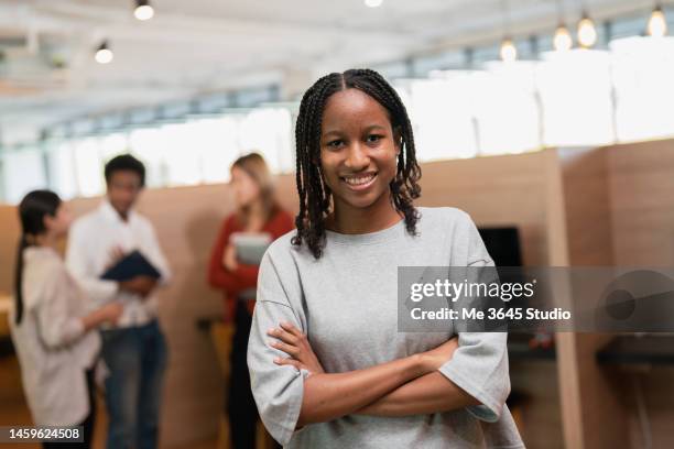 portrait of a smiling female student.students learn electronic robot technology - teacher studio portrait stock-fotos und bilder