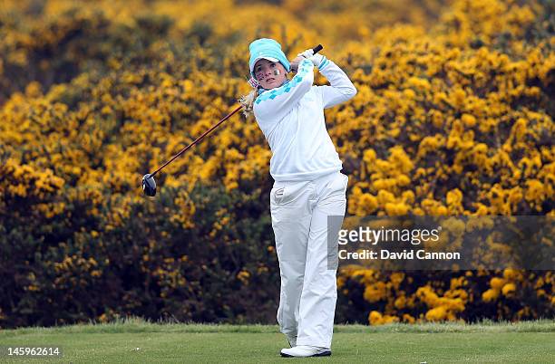 Bronte Law of England and the Great Britain and Ireland team tees off from the 10th tee against a backdrop of gorse bushes in full bloom during the...