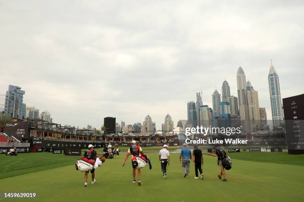 Rory McIlroy of Northern Ireland, Ryan Fox of New Zealand and Tommy Fleetwood of England walk on the 18th hole during Day One of the Hero Dubai...