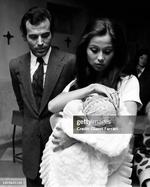 Spanish singer Julio Iglesias with his wife Isabel Preysler at the baptism of their son Julio José, Madrid, Spain, 1973