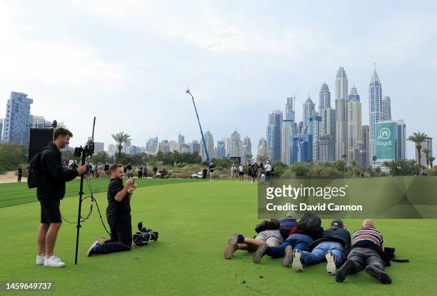 Rory McIlroy of Northern Ireland waits to play his second shot on the 13th hole as four prone photographers are captured by a Sky Television...