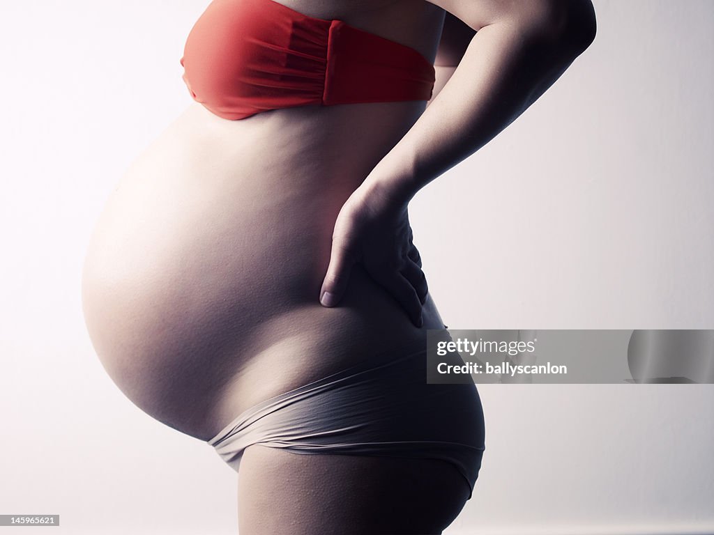 Pregnant woman on a white background