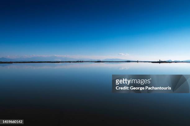 blue sky reflection on a calm lake - lake reflection stock pictures, royalty-free photos & images