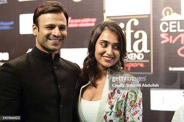 Indian actor Vivek Oberoi and wife pose on the green carpet during the IIFA Rocks Green Carpet on day two of the 2012 International India Film...
