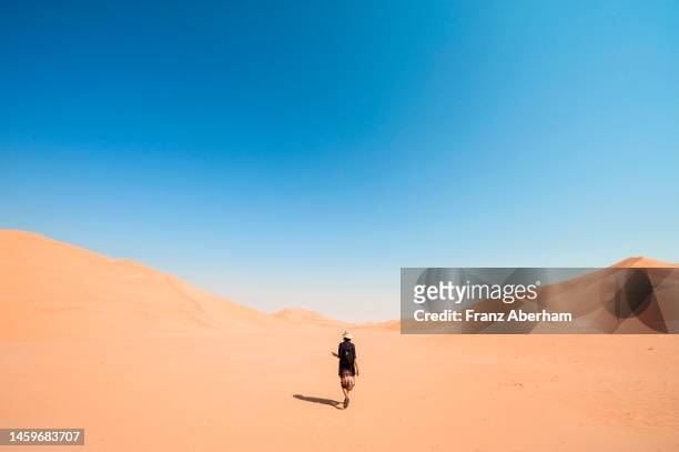 hiking in the infinity, empty quarter - hot arabic women fotografías e imágenes de stock