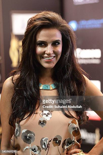 Bollywood actress Neha Dhupia poses on the green carpet during the IIFA Rocks Green Carpet on day two of the 2012 International India Film Academy...