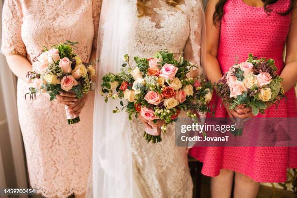 mother, bride and godmother hold wedding bouquets - patin stock-fotos und bilder