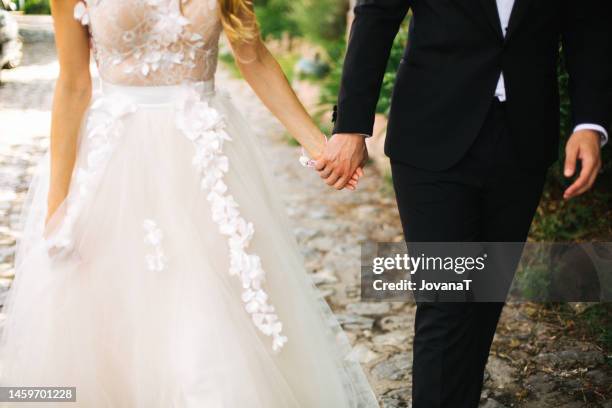 bride and groom walking on their path - noivo papel em casamento imagens e fotografias de stock