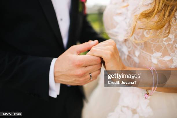 just married couple holding their hands together - platinum rings stock pictures, royalty-free photos & images