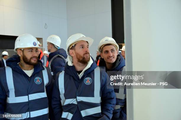 Neymar Jr, Leo Messi and Marco Verratti look at a map as PSG players visit the Paris Saint-Germain new training center on January 26, 2023 in Poissy,...