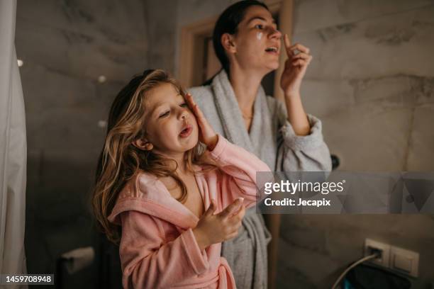 mom and daughter routine - mini robe stock pictures, royalty-free photos & images