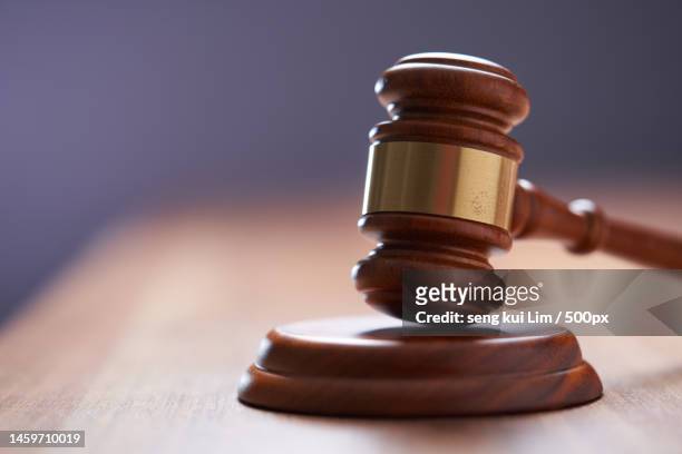 selective focus on gavel hammer on wooden table top with copy space,malaysia - gavel stock-fotos und bilder