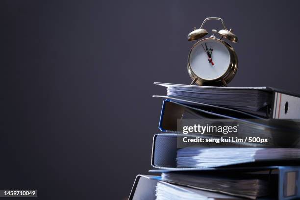 stack of document files and vintage alarm clock,malaysia - letter v or roman numeral v stock-fotos und bilder