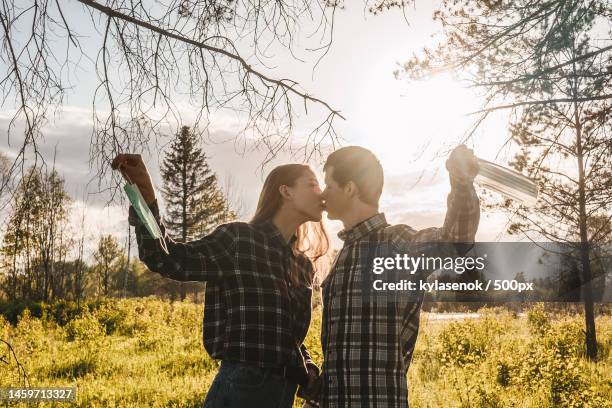 happy couple takes off protective medical mask,russia - peel off mask stock-fotos und bilder