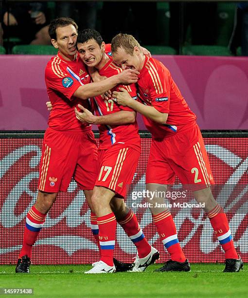 Alan Dzagoev of Russia celebrates scoring their opening goal with team mates during the UEFA EURO 2012 group A match between Russia and Czech...