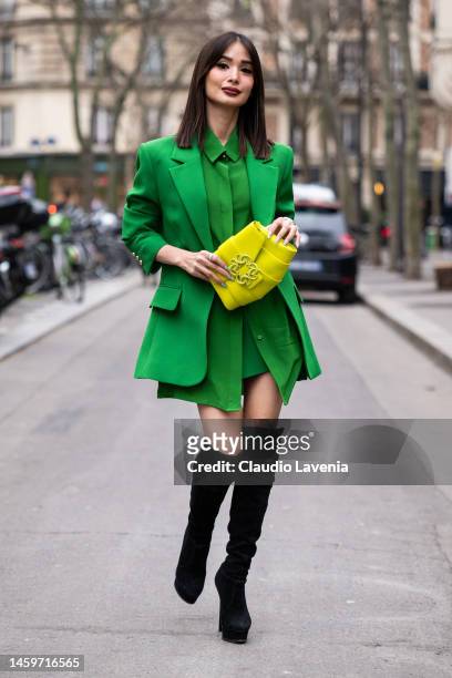 Heart Evangelista wears a green shirt, green blazer, yellow bag and black over the knees boots, outside Elie Saab, during Paris Fashion Week -...