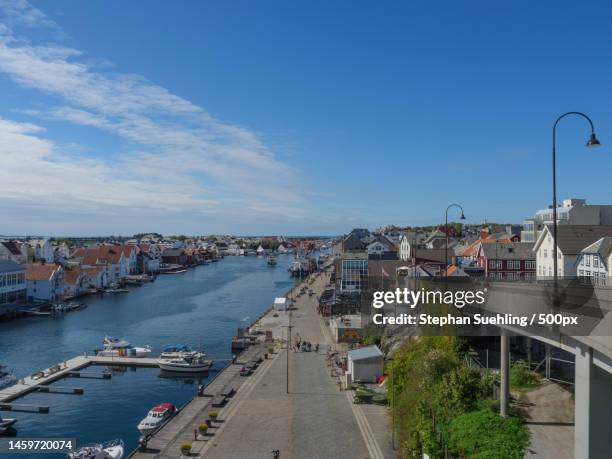 high angle view of river amidst buildings in city,haugesund,norway - haugesund stockfoto's en -beelden