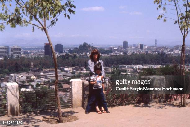 vintage photo of a beautiful woman and her young son overlooking the city of santiago, chile, 1981 - old photograph stock pictures, royalty-free photos & images