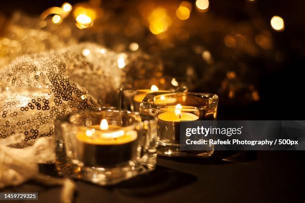 close-up of illuminated tea lights on table,india - tealight stock pictures, royalty-free photos & images