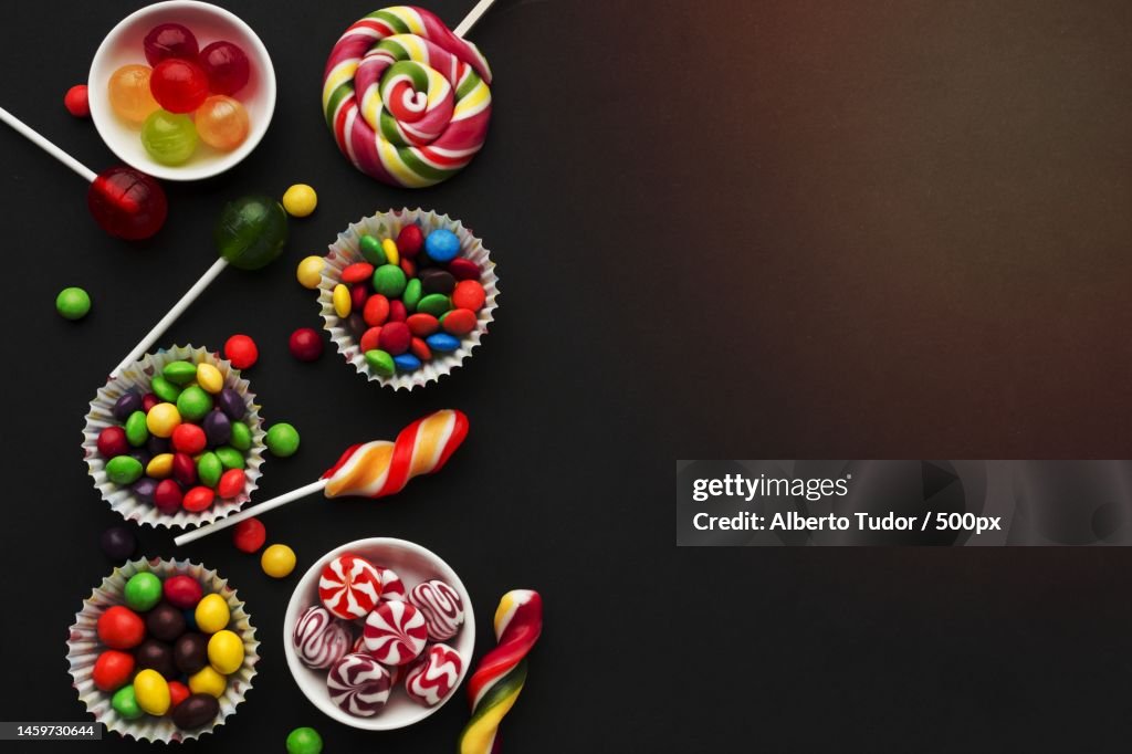 Top view tasty candies black table