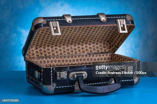 retro,vintage open suitcase on a blue background - open suitcase stock pictures, royalty-free photos & images