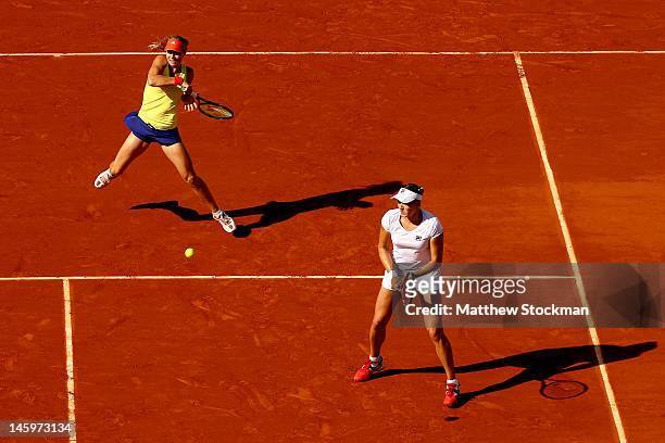 Maria Kirilenko of Russia plays a forehand behind her partner Nadia Petrova of Russia during their women's doubles final match against Roberta Vinci...