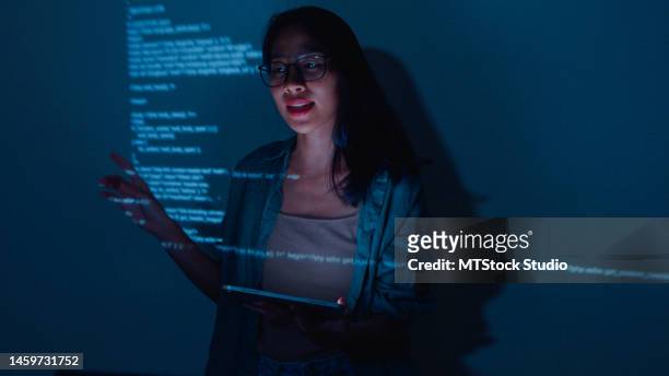 young asian woman software developers mentor leader manager talking to executive team analyzing source code in office at night. - interactive keynote stock pictures, royalty-free photos & images