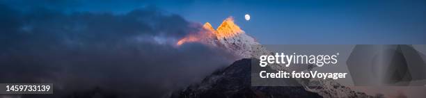 moonrise over golden sunset peak snowy mountain summit panorama himalayas - himalayas climbers stock pictures, royalty-free photos & images