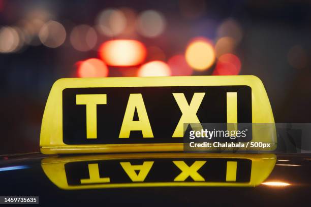 close-up of taxi sign on car at night,prague,czech republic - taxi sign stock pictures, royalty-free photos & images