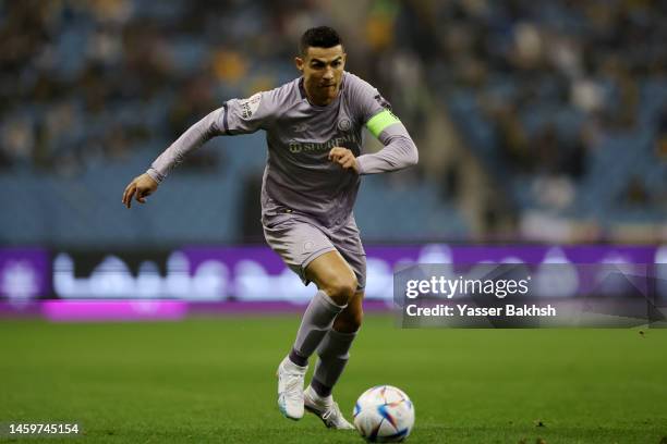 Cristiano Ronaldo of Al Nassr runs with the ball during the Saudi Super Cup Semi-Final match between Al Ittihad and Al Nassr at King Fahd...