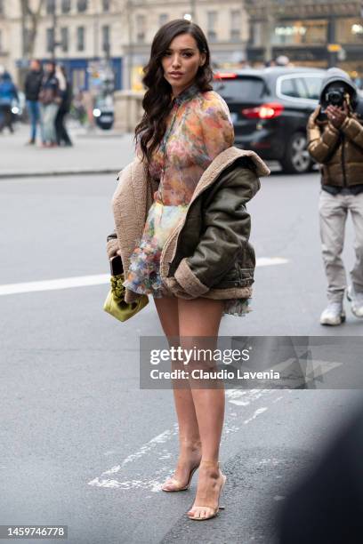 Kleofina Pnishi wears a floral print sheer mini dress, green leather jacket with fur details, green mini velvet bag and nude heels, outside Viktor &...