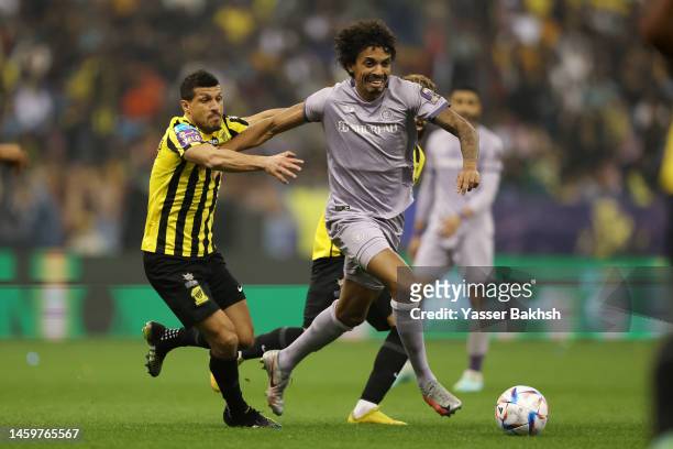 Luiz Gustavo of Al Nassr battles for possession with Tarek Hamed of Al Ittihad during the Saudi Super Cup Semi-Final match between Al Ittihad and Al...
